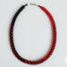 Handmade Crimson Noir Kumihimo beaded necklace featuring red and black glass seed beads with silver clasp on light background